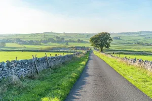 Vista Prints: Road leads to village surrounded by green fields in autumn in Bakewell