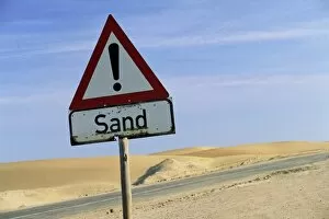 Road sign warning of sand