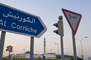 Road signs and minaret of the Grand Mosque iluminated at dusk