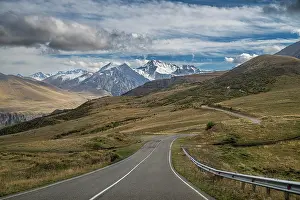 Trail Prints: Road winds through mountains leading to Mount Elbrus in Kabardino-Balkaria
