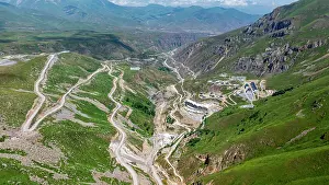Vast Prints: Roads wind through the green valleys of Qarabaqh with distant mountains touching the sky in Azerbaijan