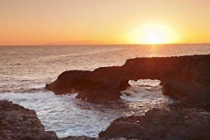 El Hierro Prints: Rock arch at sunrise, Charco Manso Bay, Punta Norte near Echedo, UNESCO biosphere reserve