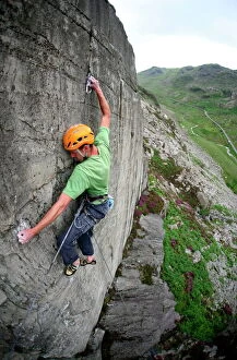 Images Dated 23rd June 2007: A rock climber makes a first ascent of on the cliffs above the Llanberis Pass