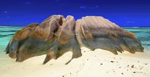 Retreat Prints: Rock formation on the beach with clear water and blue sky at a sunny day in La Digue