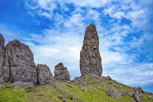 Foreground Prints: Rock formation rises on a hill in the Trotternish escarpment of the Isle of Skye in Scotland with cloudy sky