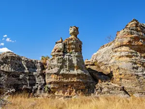 Trail Prints: Rock formation shaped like a crowned queen stands tall amidst the natural landscape in Isalo