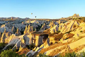 Rugged Terrain Prints: Rock formations with distant views of Uchisar Castle at sunrise