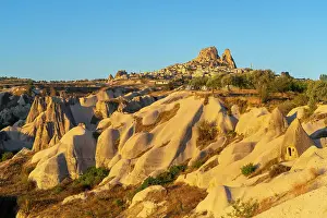 Historic Castle Prints: Rock formations with distant views of Uchisar Castle at sunrise