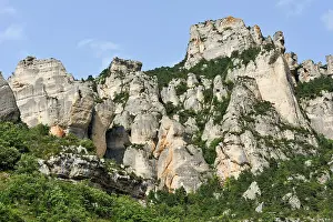 Breathtaking Prints: Rock formations rise in Jonte Gorges with green vegetation below in Lozere region of France