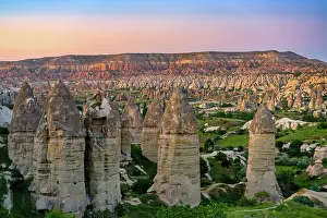 Cappadocia Prints: Rock formations in Rocket Valley with Red and Rose Valley at sunset in Cappadocia