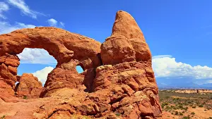 Large Prints: Rock formations stand tall under a bright sky in Arches National Park