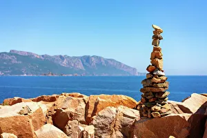 Cairn Prints: Rock towers with coastal landscape of Sardinia in the background