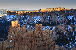 Sunset Point Prints: Rocks lit by late afternoon sun with snow