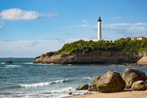 Aquitaine Prints: Rocks on the sandy beach and the lighthouse in Biarritz, Pyrenees Atlantiques, Aquitaine