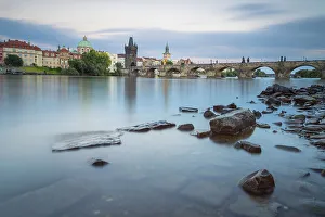 Mala Strana Prints: Rocks in Vltava river near Charles Bridge at twilight
