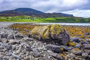 Seashore Prints: Rocky beach at Staffin with green hills and cloudy sky on the Isle of Skye in United Kingdom