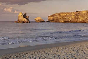 Rocky coast near Torre dell Orso, Due Sorello Rocks (Two sisters) at sunset, Adriatic Sea