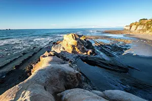 Zealand Prints: Rocky coastline features cliffs and waves at low tide in Cape Foulwind on South Island New Zealand