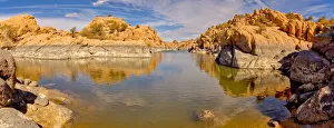 Rocky lagoon in Watson Lake along Lakeshore Trail, gray rock shows how much water volume
