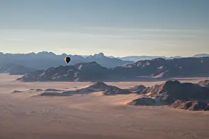 Deserts Prints: Rocky mountains, aerial view with hot air balloon flying over it, Namibia, Africa
