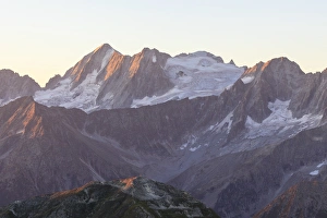 Alpenglow Prints: Rocky peak of Cima Presanella seen from Monte Tonale at dawn, Valcamonica, border Lombardy