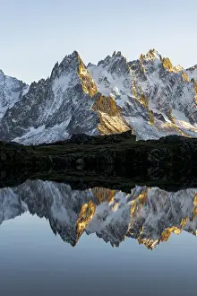 Mont Blanc Prints: Rocky peaks of Aiguilles de Chamonix reflected in Lacs des Cheserys at sunset