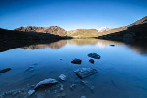 Fisheye Prints: The rocky peaks reflected in Lake Umbrail at sunset, Stelvio Pass, Valtellina, Lombardy