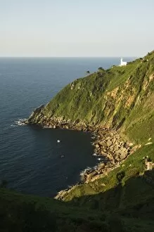 Rocky peninsula with lighthouse on cliff
