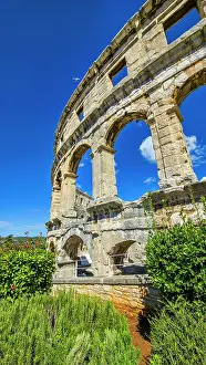 Stones Prints: Roman amphitheatre in Pula showcases ancient architecture in blue sky