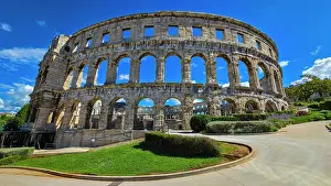 Amphitheatre Prints: Roman amphitheatre in Pula stands tall under blue skies in Istria, Croatia