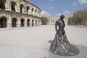 Bull Fighter Prints: Roman arena with bullfighter statue, Nimes, Languedoc, France, Europe