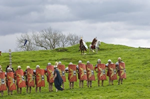 Roman soldiers of Ermine Street Guard, in line abreast with shields and stabbing swords