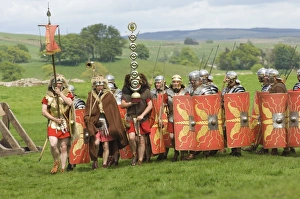 Roman soldiers of the Ermine Street Guard, marching in column led by Standard Bearers