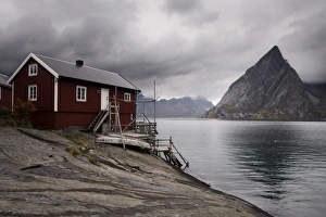 Images Dated 28th December 2006: Rorbuer (fishermens huts) on fjord with mountains, Lofoten Islands