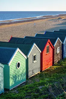 Suffolk Prints: A row of colourful beach huts on the beach at Southwold in the county of Suffolk