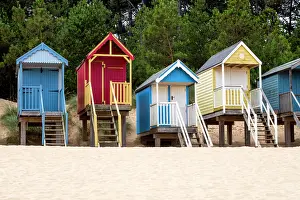 Relax Prints: A row of colourful beach huts on the sand at Wells next the Sea in North Norfolk
