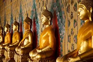 Images Dated 15th June 2010: A row of golden seated Buddha statues located inside Wat Arun (The Temple of the Dawn)