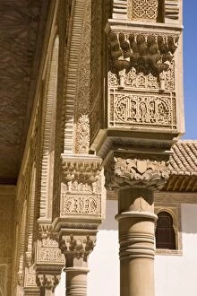 Row of intricately decorated columns in the Patio de los Arrayanes, Casa Real