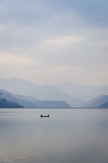 A rowboat on Phewa Tal (Phewa Lake), Pokhara, Nepal, Asia