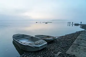 Fishermen Prints: Rowing boats on shore with fishermen in background preparing for fish harvest on foggy morning