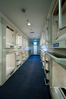 Rows and stacks of sleeping compartments along one corridor at a capsule hotel in Osaka Rows and stacks of sleeping compartments along one corridor at a capsule hotel in Osaka