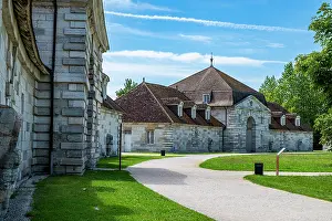 Attractions Prints: Royal Saltworks in Arc-et-Senans showcases historic architecture and landscape in France during a sunny day