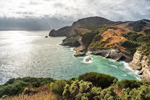 Zealand Prints: Rugged cliffs meet turquoise waters in Golden Bay along the South Island coastline in New Zealand