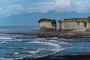 Zealand Prints: Rugged sea cliffs tower above the waves along the West Coast of New Zealand's South Island near Westport