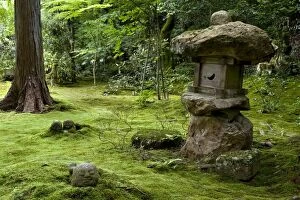 A rugged stone lantern accents a moss garden at Sanzenin Temple in Ohara