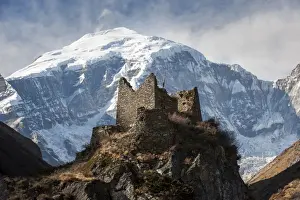 Bhutan Prints: A ruined ancient Dzong at Jangothang with the face of Jomolhari mountain visible behind