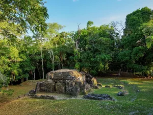 Sites Prints: Ruins of Group A at Uaxactun Archaeological Site in Peten Department Guatemala among lush greenery and trees