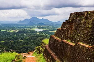 Fortification Gallery: Ruins of King Kassapas Palace in front of the view from of Sigiriya Rock Fortress (Lion Rock)
