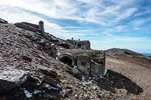 Granada Prints: Ruins of a stone refuge and civil war shelter stand among rocky terrain in the Sierra Nevada mountains of Andalusia