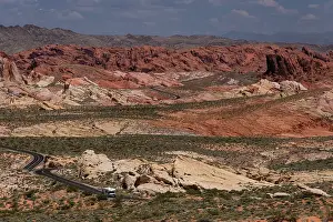 Highway Prints: An RV Camper Van Recreational Vehicle travels the highway of White Domes Road through the Valley of Fire State Park
